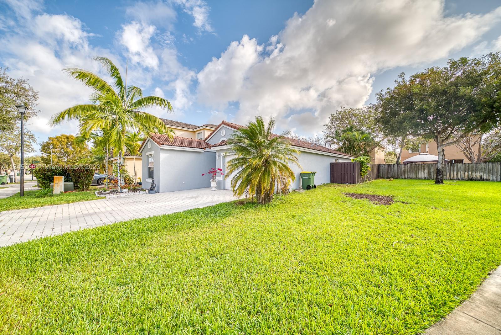 1635 Southeast 20th Place Homestead, FL 33035 - Photo 2 of 28 a front view of house with yard and green space