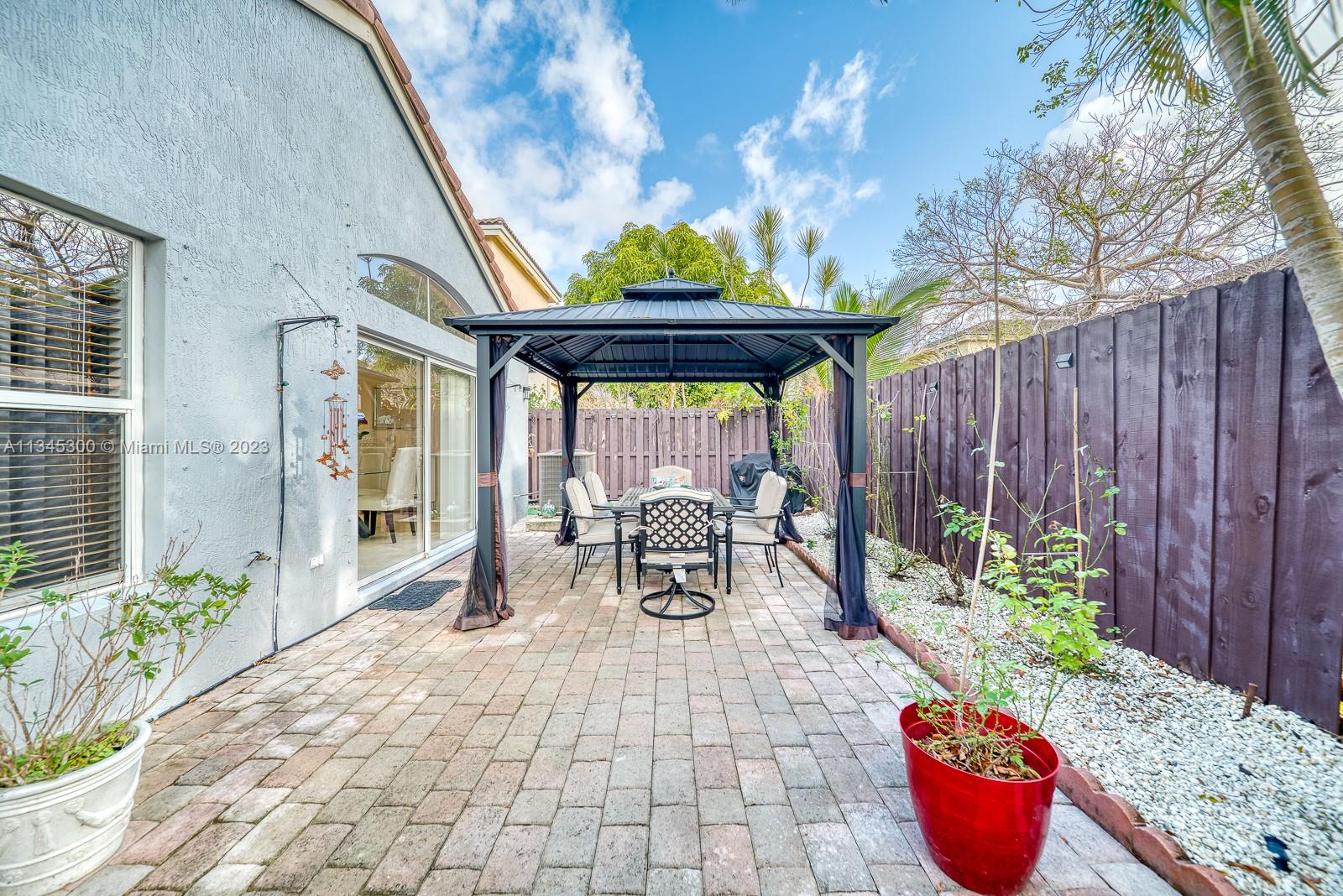 1635 Southeast 20th Place Homestead, FL 33035 - Photo 23 of 28 a outdoor dining space with furniture and potted plants
