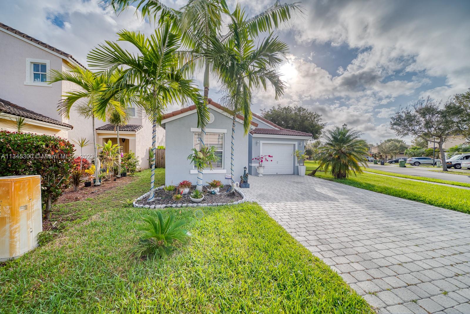 1635 Southeast 20th Place Homestead, FL 33035 - Photo 28 of 28 a front view of a house with swimming pool having outdoor seating