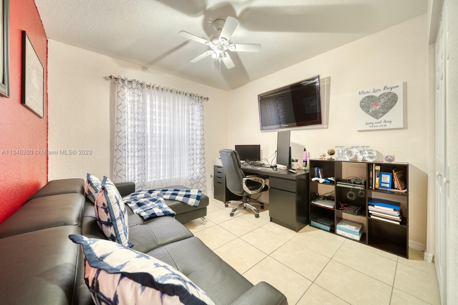 1635 Southeast 20th Place Homestead, FL 33035 - Photo 3 of 28 a living room with furniture and a flat screen tv