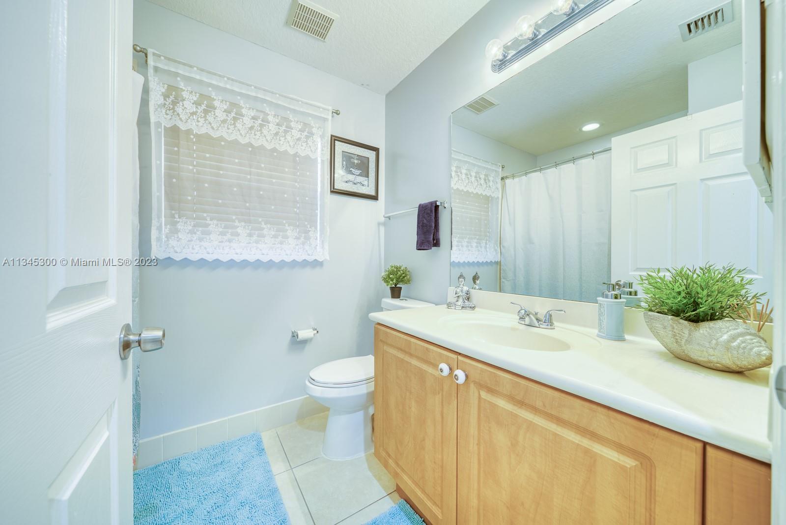 1635 Southeast 20th Place Homestead, FL 33035 - Photo 4 of 28 a bathroom with a sink a toilet and shower