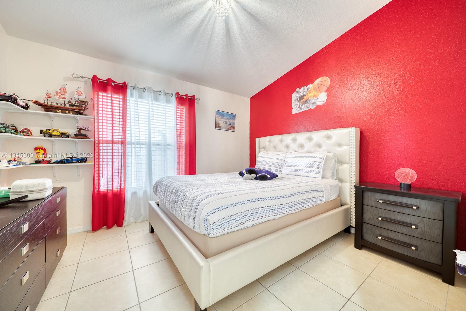 1635 Southeast 20th Place Homestead, FL 33035 - Photo 7 of 28 a bedroom with a bed and a dresser