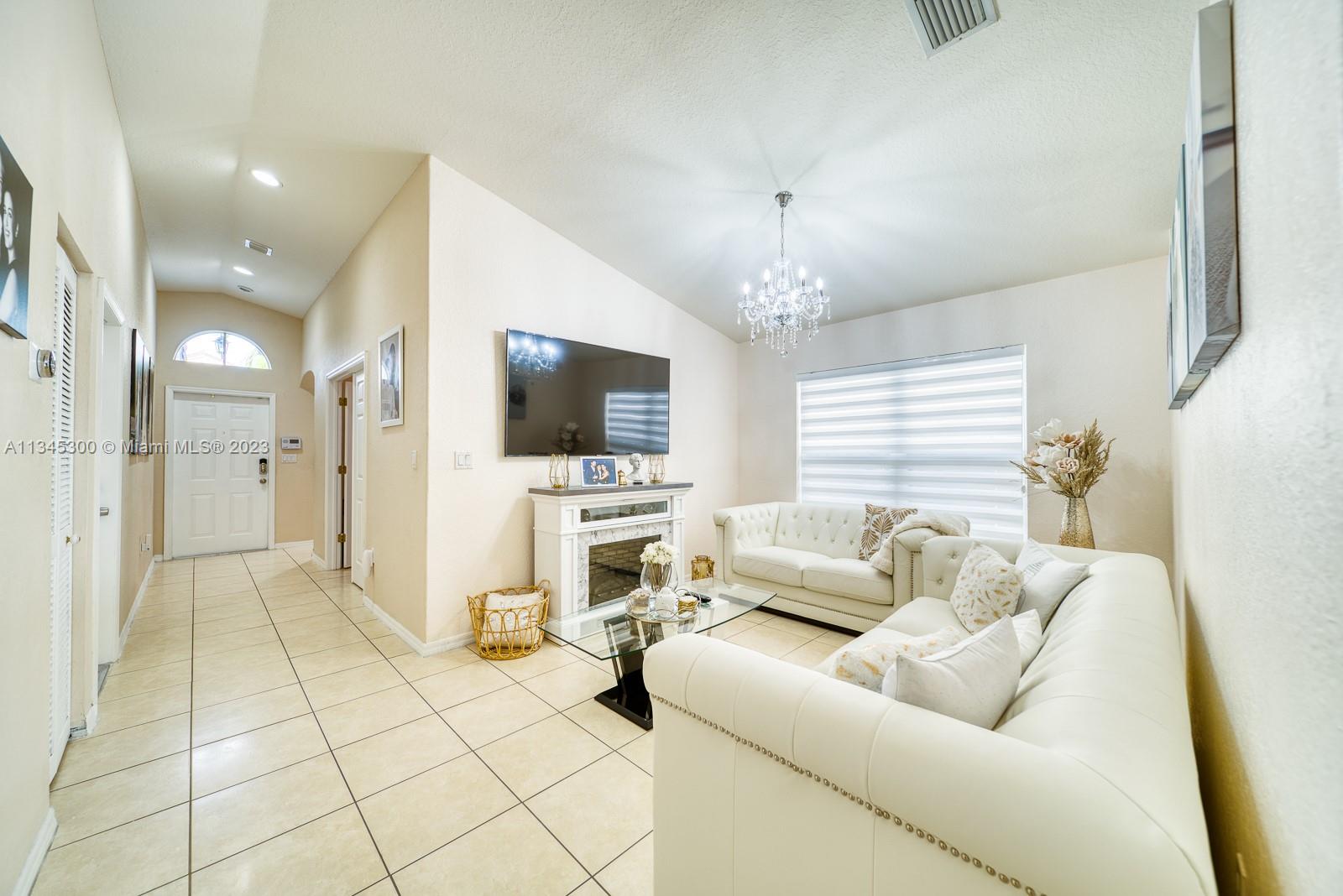 1635 Southeast 20th Place Homestead, FL 33035 - Photo 9 of 28 a living room with furniture and a flat screen tv