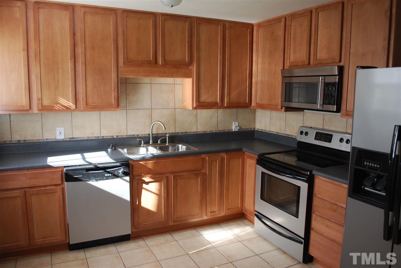 1613 Seminole Trail Raleigh, NC 27609 - Photo 2 of 5 a kitchen with stainless steel appliances granite countertop a stove a sink and a microwave