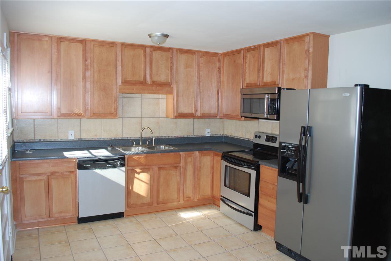 1613 Seminole Trail Raleigh, NC 27609 - Photo 3 of 5 a kitchen with stainless steel appliances granite countertop a stove a sink and a refrigerator