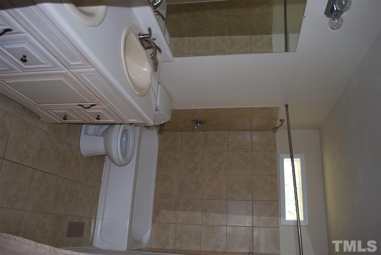 1613 Seminole Trail Raleigh, NC 27609 - Photo 4 of 5 a bathroom with a sink a toilet and shower