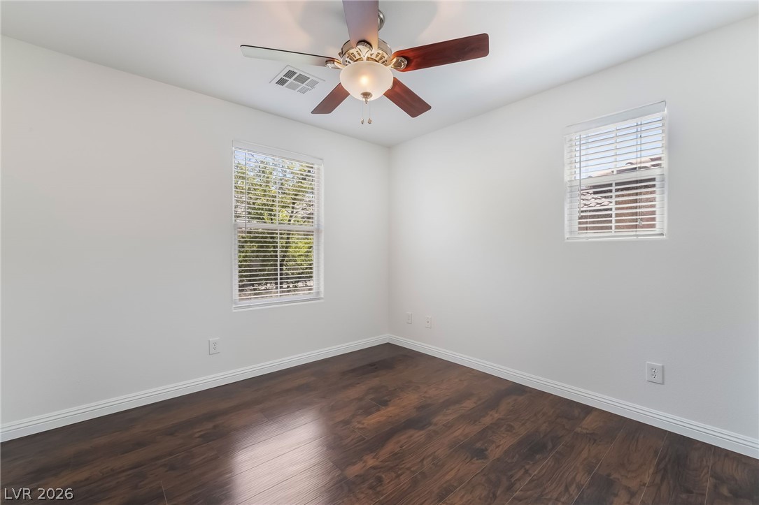 3175 Via Seranova Henderson, NV 89044 - Photo 29 of 45 This airy room features rich hardwood flooring and abundant natural light, creating a comfortable living space.