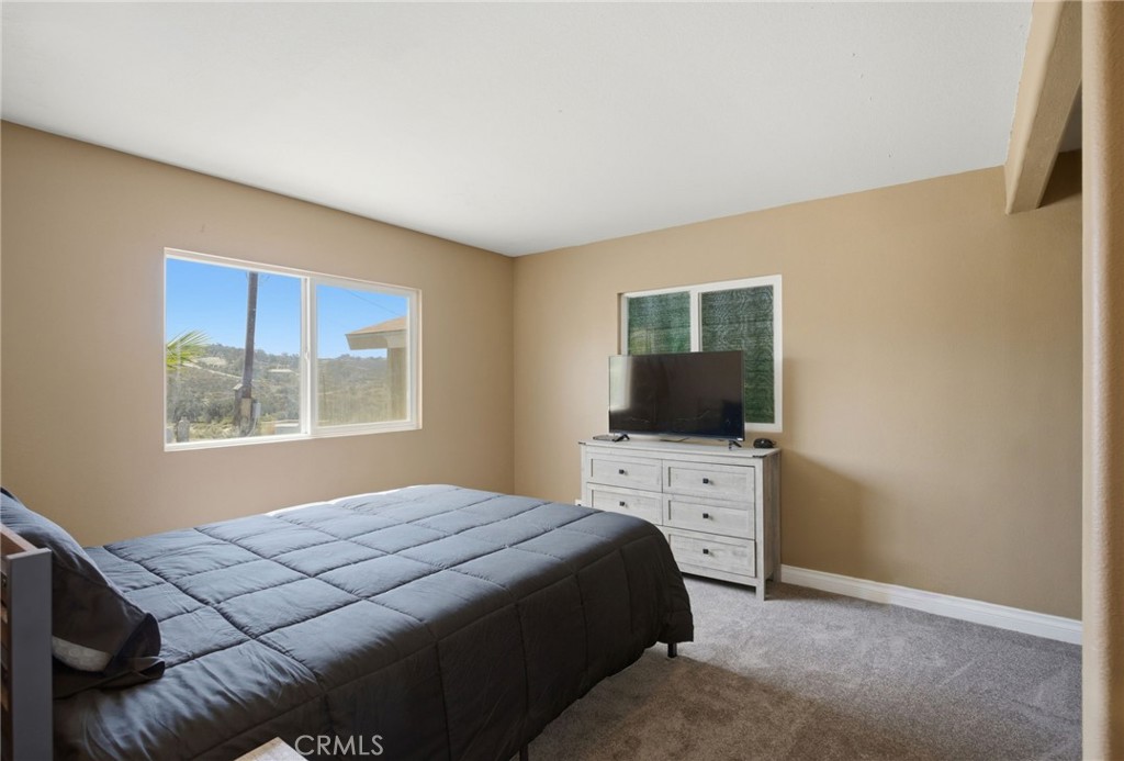 40100 Owl Valley Road Temecula, CA 92592 - Photo 21 of 44 a bedroom with a bed and a flat screen tv