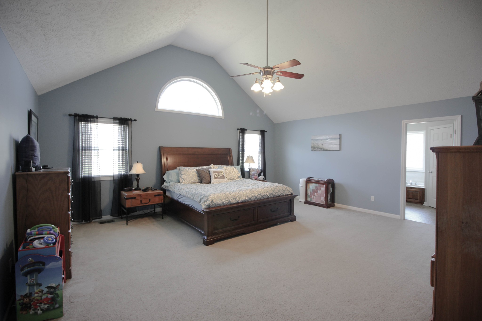 376 Spring Meadows Lane Morrison, TN 37357 - Photo 7 of 16 a spacious bedroom with a bed and a chandelier