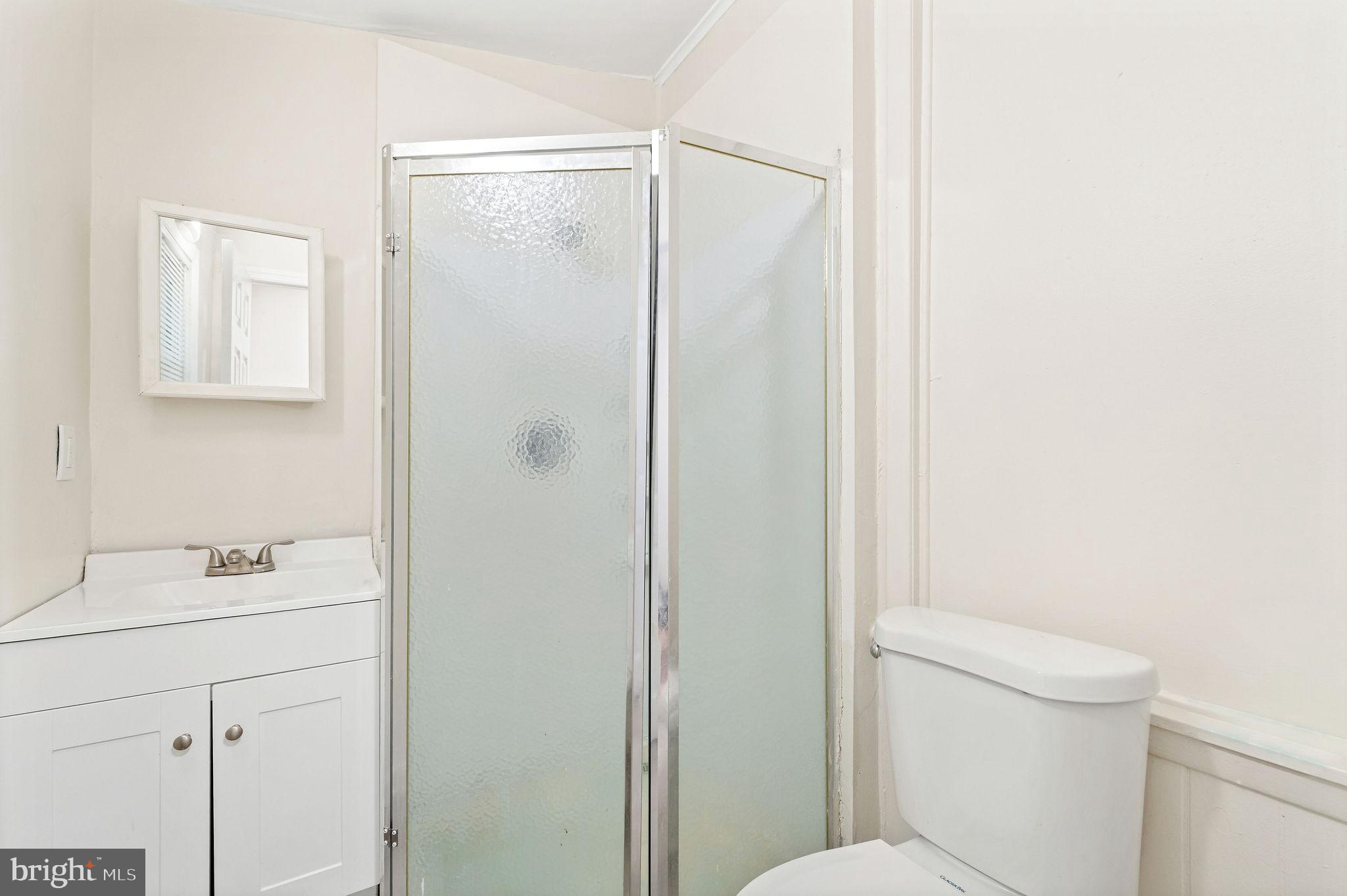 705 North 7th Street Camden, NJ 08102 - Photo 11 of 25 a bathroom with a sink a toilet and shower
