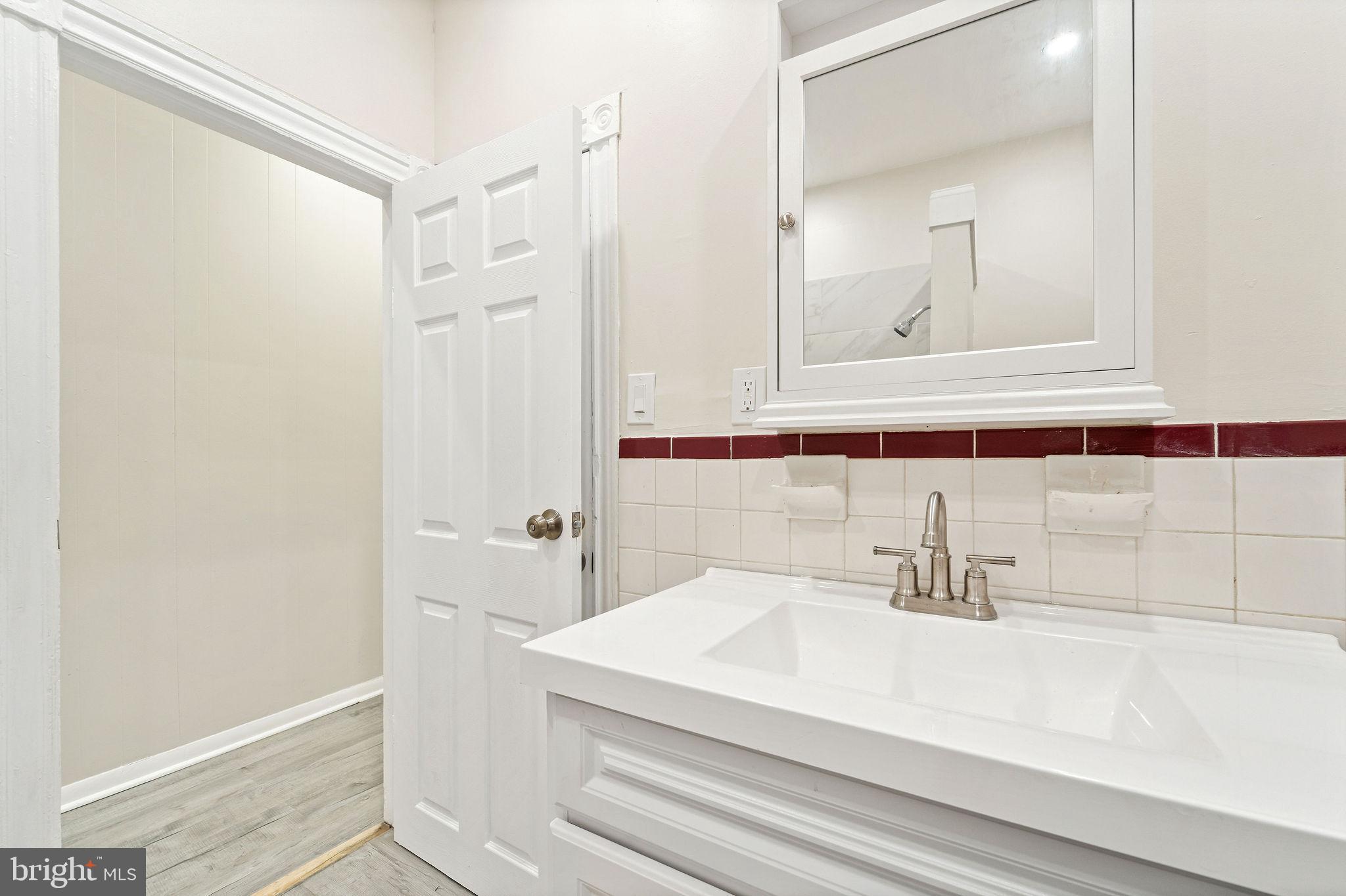 705 North 7th Street Camden, NJ 08102 - Photo 16 of 25 a bathroom with a sink and a mirror