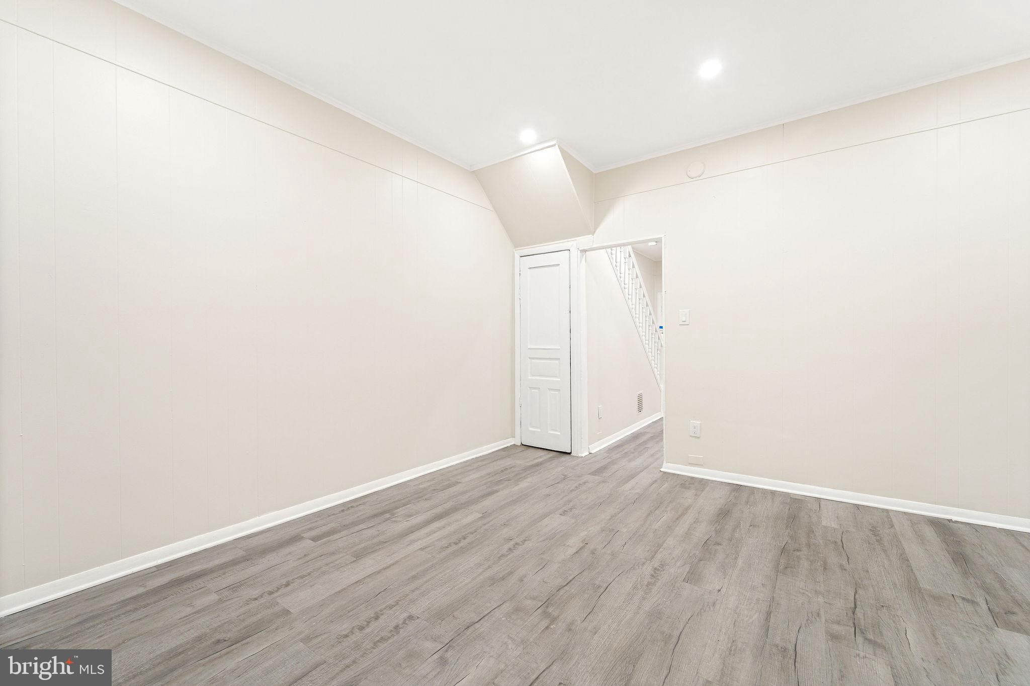 705 North 7th Street Camden, NJ 08102 - Photo 6 of 25 an empty room with wooden floor and white walls