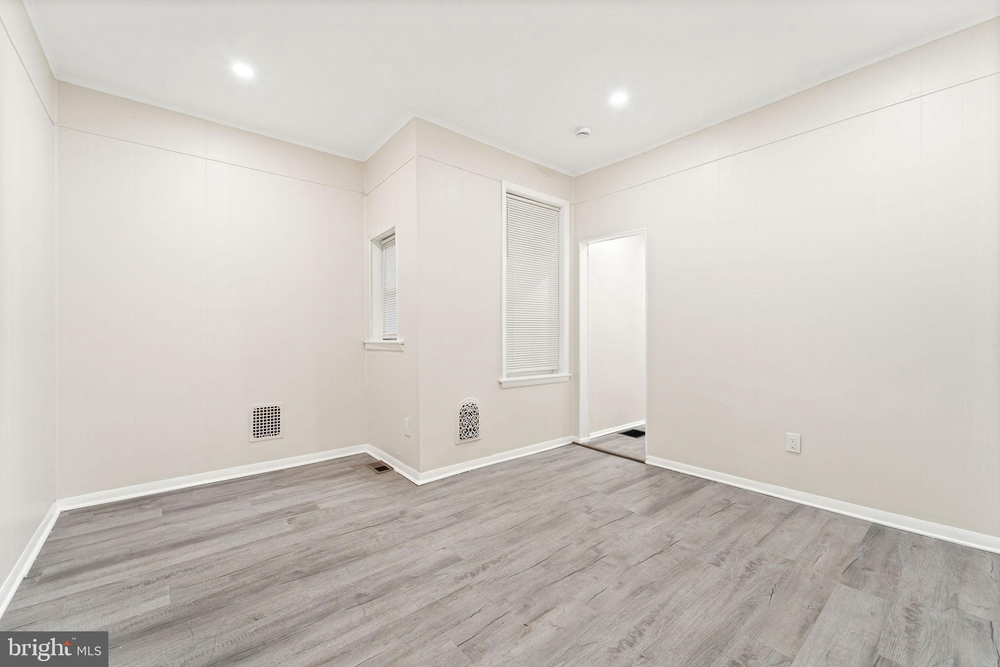 705 North 7th Street Camden, NJ 08102 - Photo 7 of 25 an empty room with wooden floor and windows