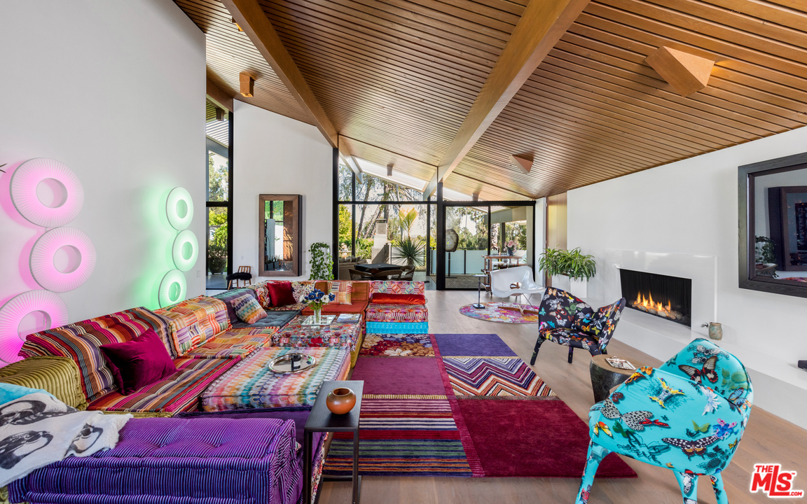920 Foothill Road Beverly Hills, CA 90210 - Photo 8 of 26 a living room with furniture fireplace and a large window