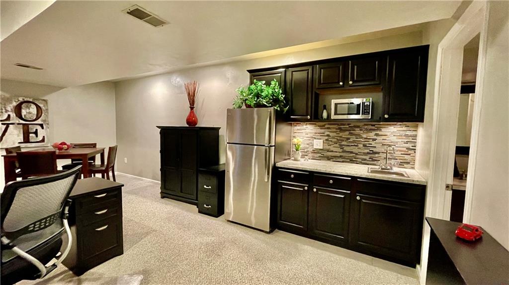 681 Adele Drive Irwin, PA 15642 - Photo 32 of 36 a kitchen with kitchen island a refrigerator stove and microwave