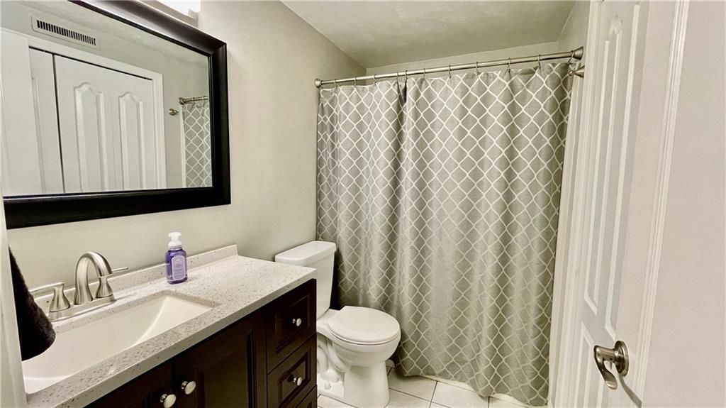 681 Adele Drive Irwin, PA 15642 - Photo 33 of 36 a bathroom with a granite countertop sink toilet and a mirror