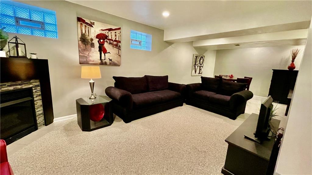 681 Adele Drive Irwin, PA 15642 - Photo 36 of 36 a living room with furniture a flat screen tv and a fireplace