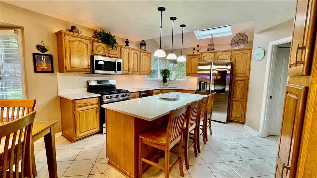 681 Adele Drive Irwin, PA 15642 - Photo 4 of 36 a kitchen that has a lot of cabinets in it and appliances