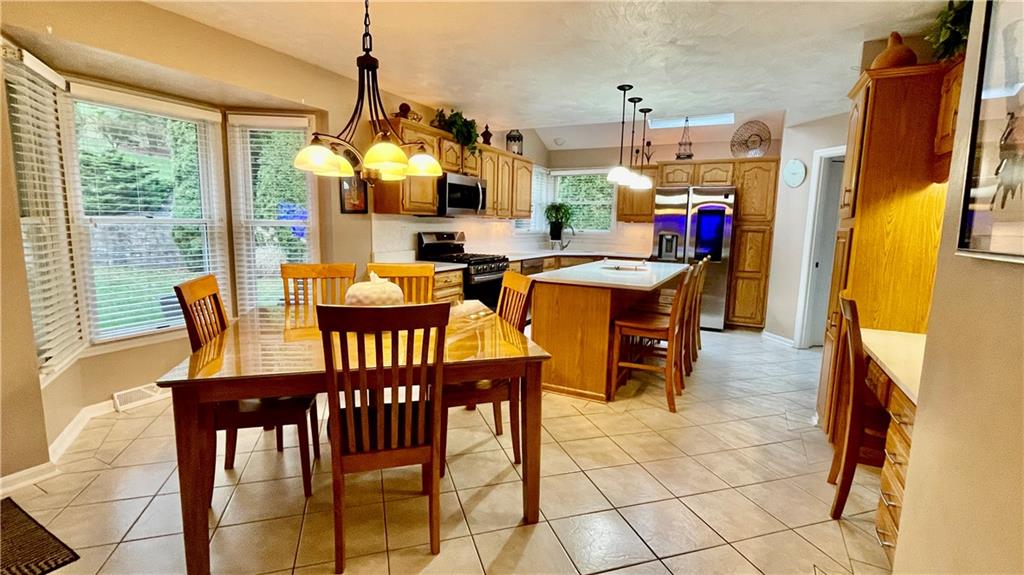 681 Adele Drive Irwin, PA 15642 - Photo 6 of 36 a view of a dining room with furniture window and outside view