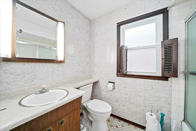 a bathroom with a bathtub and a window