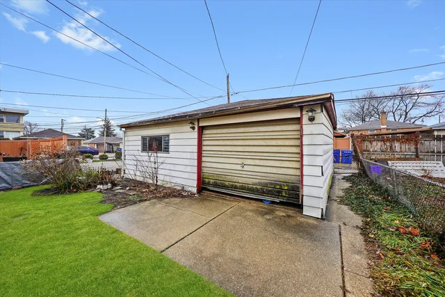 an aerial view of residential houses with outdoor space and parking
