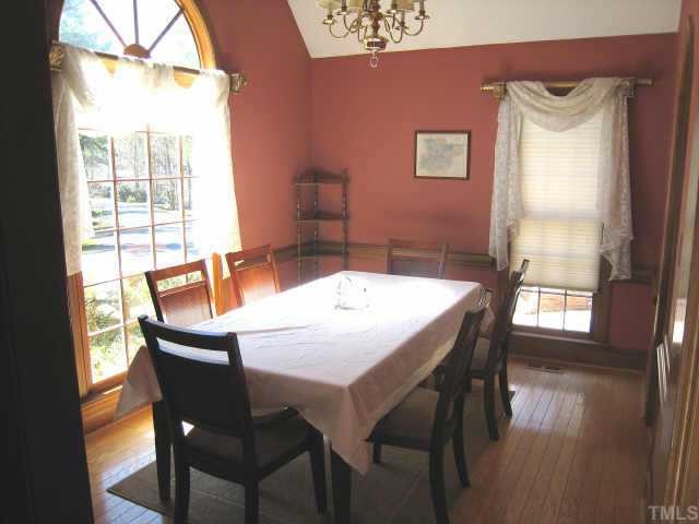 4804 Lancashire Drive Raleigh, NC 27613 - Photo 6 of 10 a view of a dining room with furniture and wooden floor