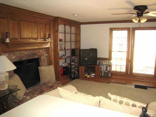 4804 Lancashire Drive Raleigh, NC 27613 - Photo 8 of 10 a living room with furniture a fireplace and a window