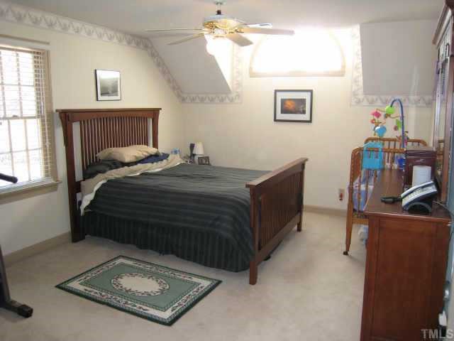 4804 Lancashire Drive Raleigh, NC 27613 - Photo 9 of 10 a bedroom with a bed a window and dresser