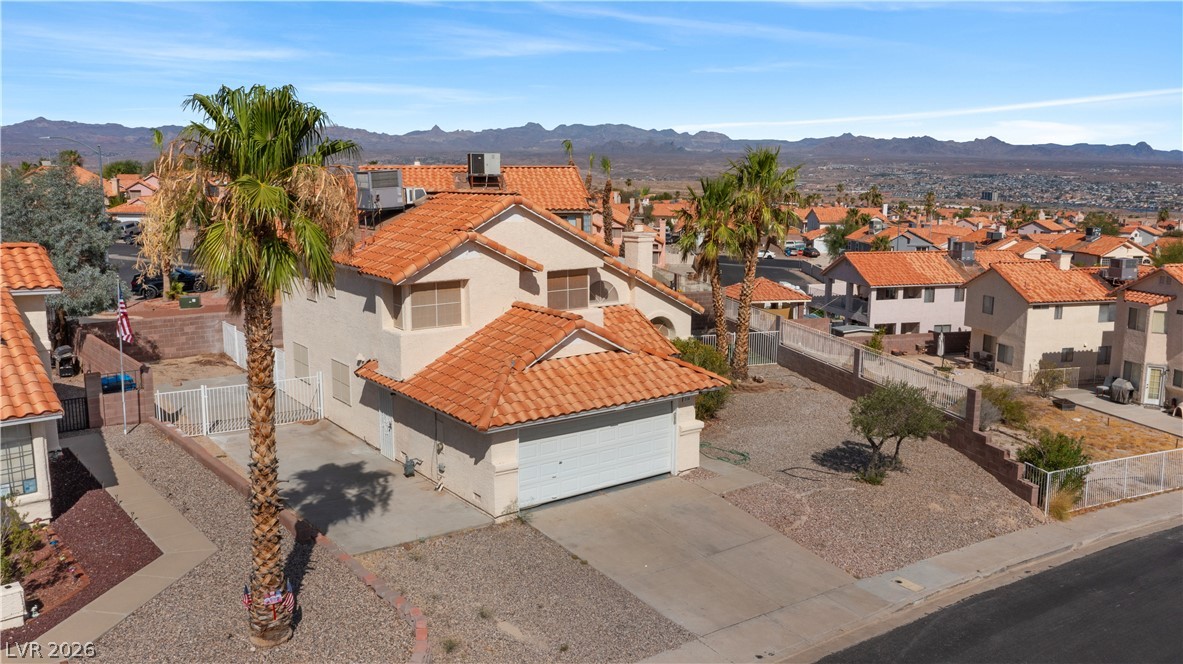 3156 Terrace View Drive Laughlin, NV 89029 - Photo 94 of 94 An aerial perspective showcases the home's terracotta roof and attached garage, complemented by the desert landscape.