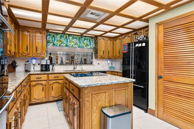 a kitchen with stainless steel appliances granite countertop a sink a stove and a wooden floors