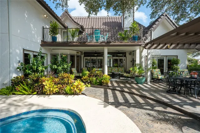 a view of a house with backyard sitting area and garden