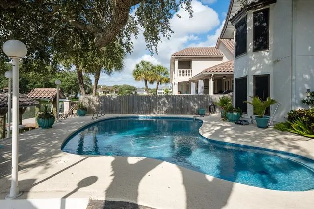 an aerial view of a house with swimming pool patio and outdoor seating