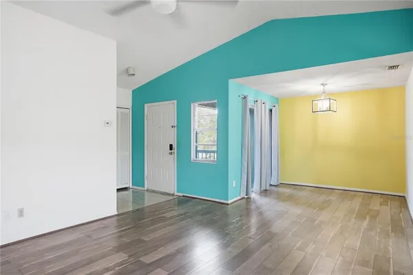 a view of a room with wooden floor closet and windows