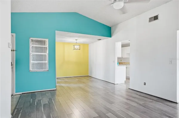 a view of a hallway with wooden floor and closet area