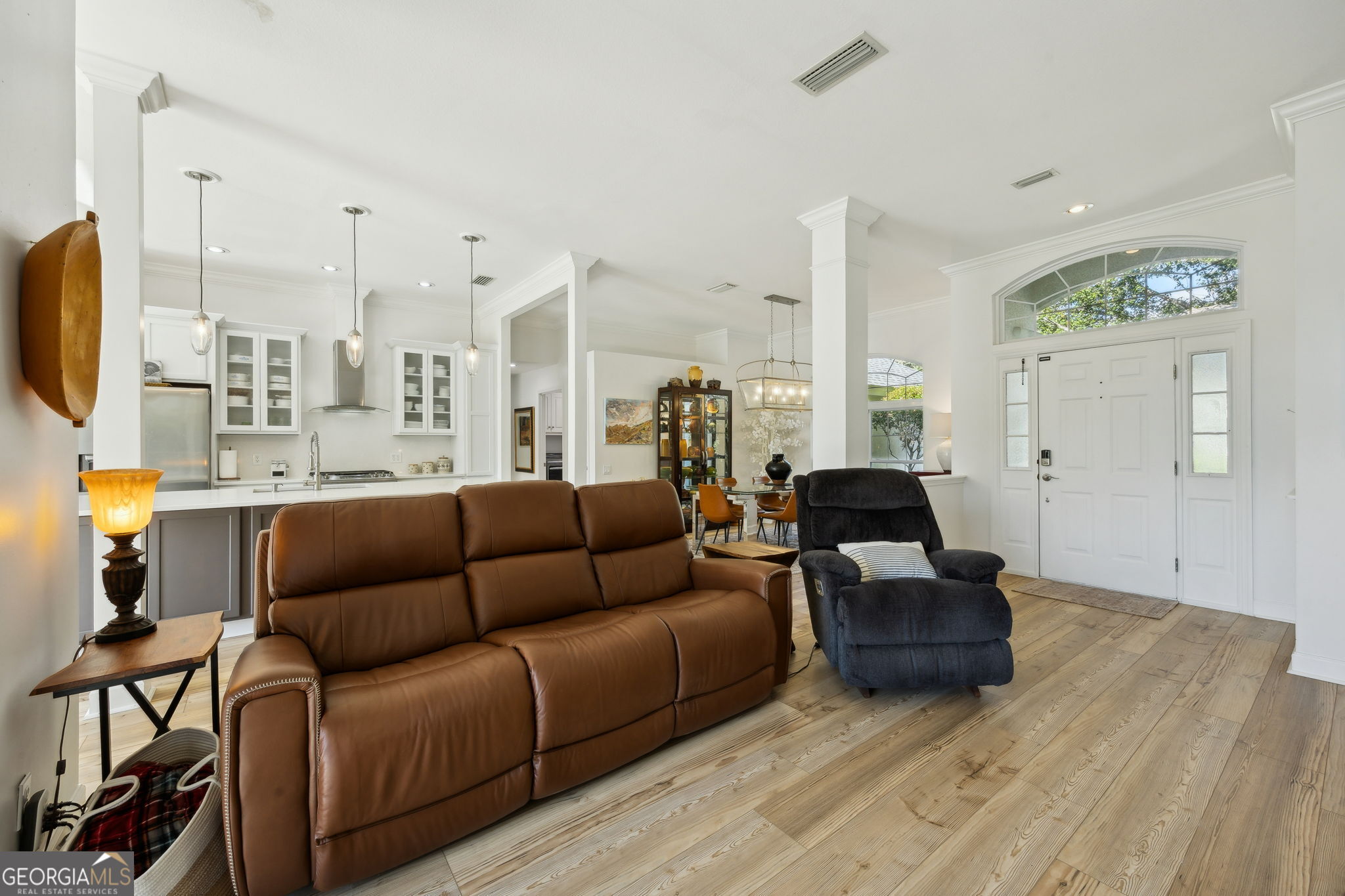 502 Cardinal Circle East St. Marys, GA 31558 - Photo 10 of 73 a living room with furniture a rug and a chandelier
