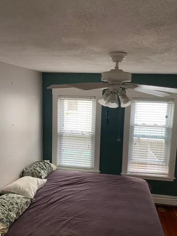 a bedroom with a bed and window