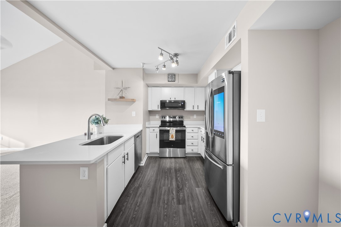 620 Fern Meadow Loop, Unit 305 Midlothian, VA 23114 - Photo 2 of 17 a kitchen with kitchen island granite countertop lots of counter top space and stainless steel appliances