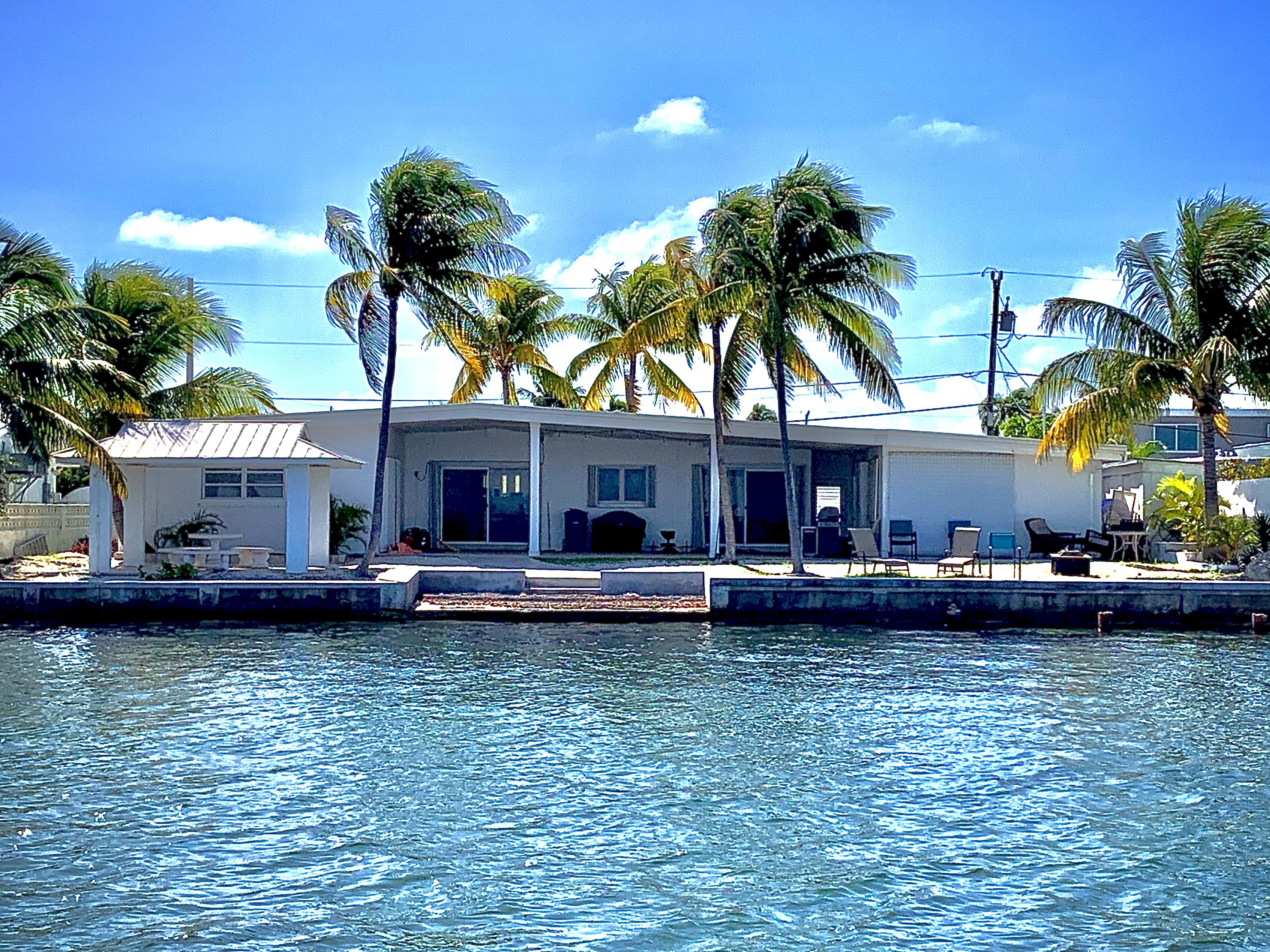 2 Allamanda Terrace Key West, FL 33040 - Photo 1 of 29 a view of a house with a swimming pool and a garden