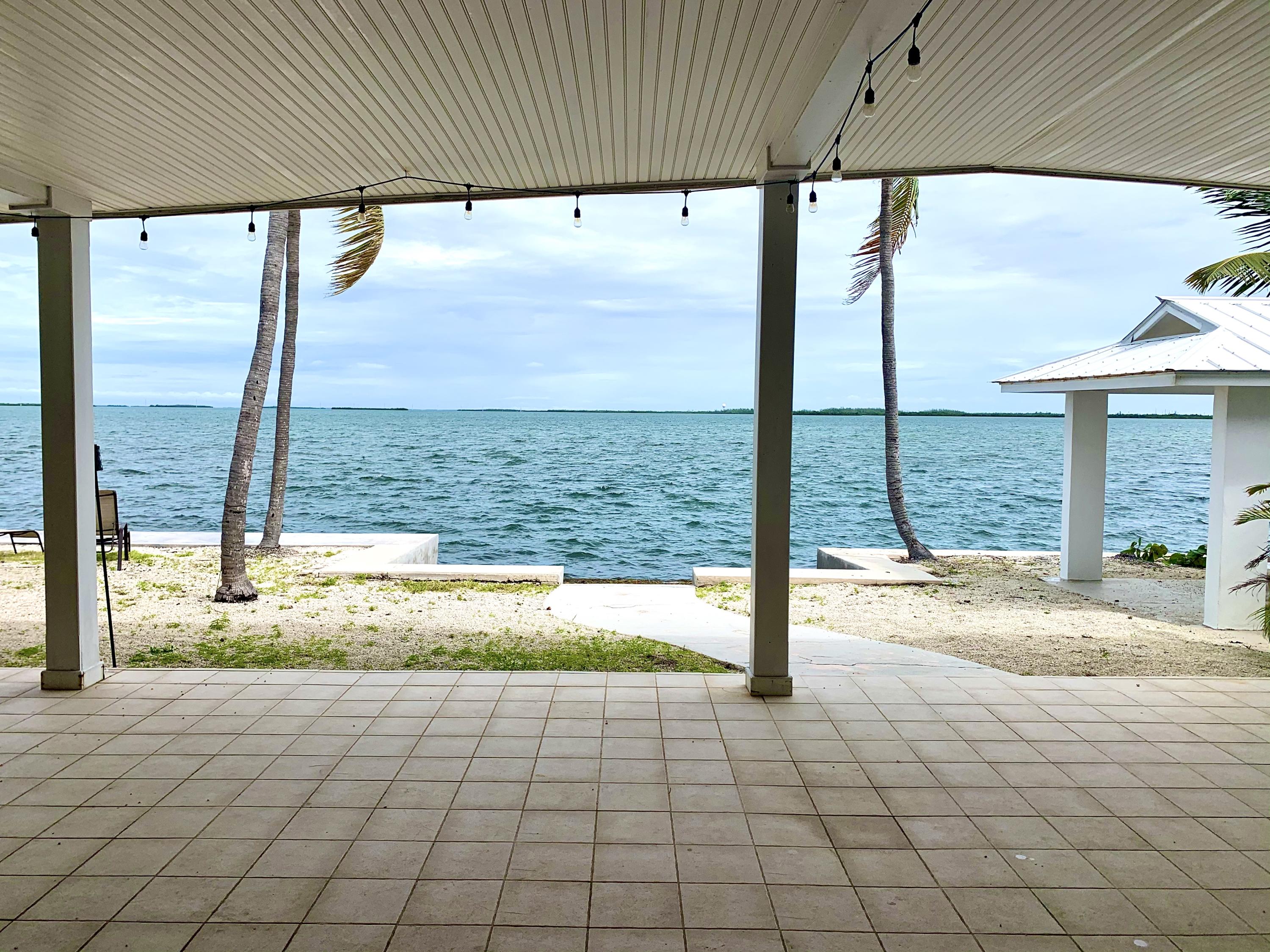 2 Allamanda Terrace Key West, FL 33040 - Photo 2 of 29 a view of a porch with a floor to ceiling window next to a yard