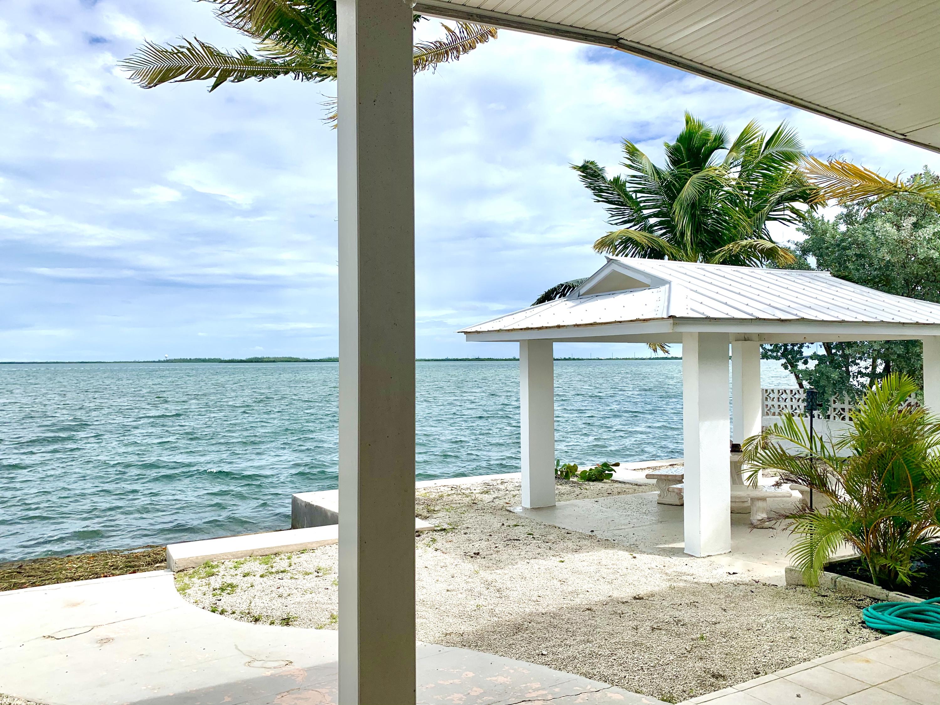 2 Allamanda Terrace Key West, FL 33040 - Photo 28 of 29 a view of a terrace with wooden floor and a bench
