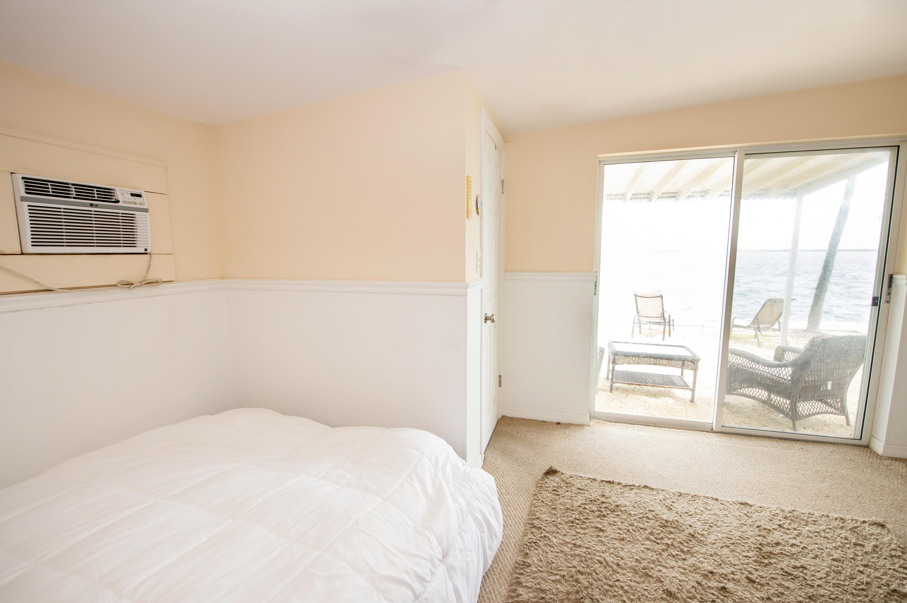 2 Allamanda Terrace Key West, FL 33040 - Photo 29 of 29 a bedroom with a bed and wooden floor