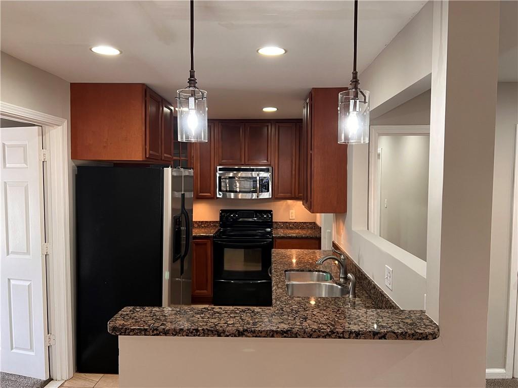 2047 Panstone Court Southwest Marietta, GA 30060 - Photo 4 of 18 a kitchen with stainless steel appliances granite countertop a refrigerator a stove a sink and a refrigerator