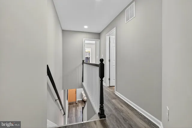 a view of a hallway with furniture and stairs