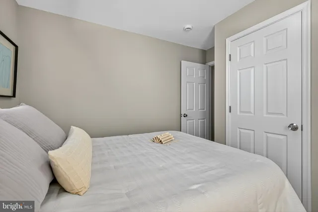 a bedroom with a bed and a mirror