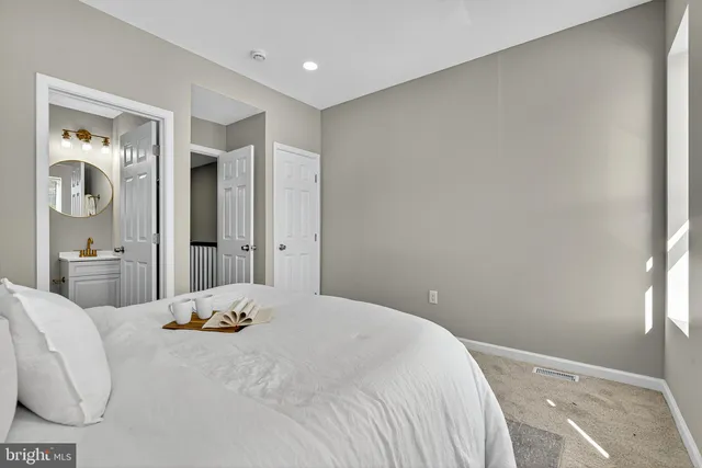 a bedroom with a bed and a couch