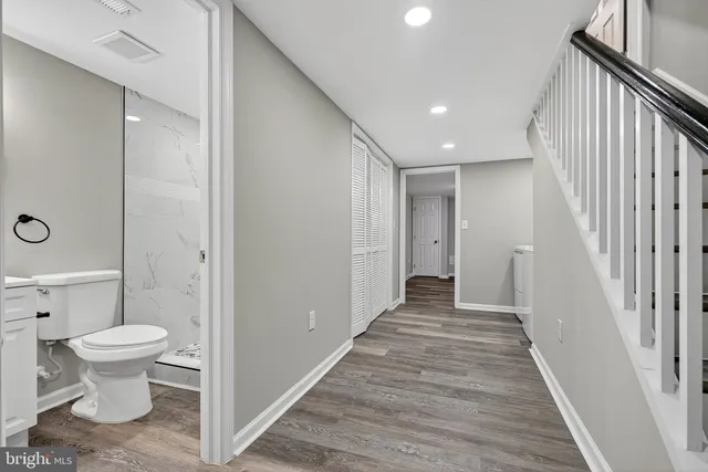 a view of a room with wooden floor and toilet