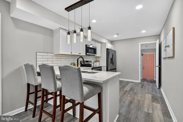 a view of kitchen with cabinets and wooden floor