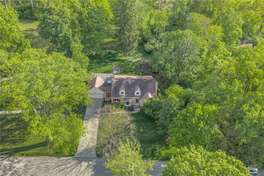 156 West Hadley Road Dayton, OH 45419 - Photo 2 of 71 This charming residence is nestled amidst lush greenery, offering a private, expansive yard.