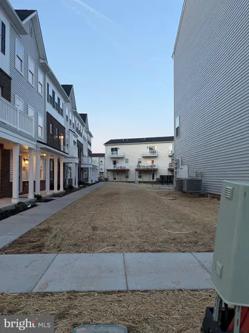 a kitchen with stainless steel appliances a refrigerator sink and white cabinets