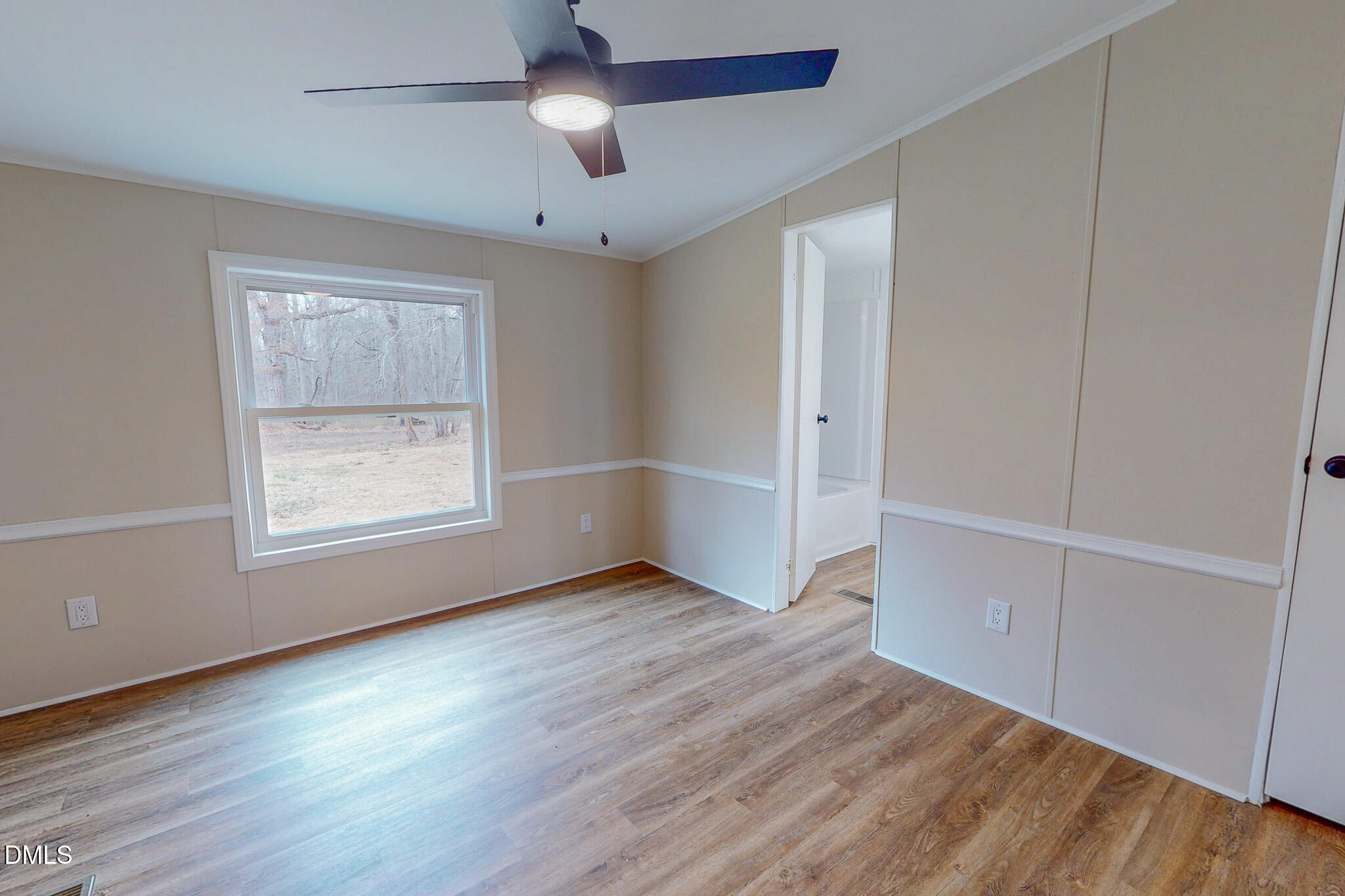 67 Halifax Road Roxboro, NC 27574 - Photo 15 of 48 an empty room with wooden floor chandelier fan and windows